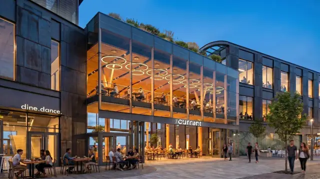 The Current at dusk, with dining along the plaza