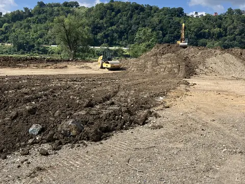 Earthwork along the riverbank. Site work, August 2026