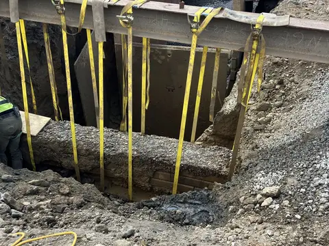 Trench shoring in place. Site work, August 2026