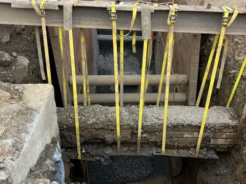 Rigging on a shored trench. Site work, August 2026