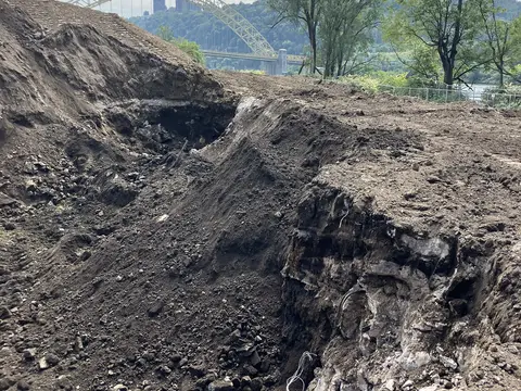 Excavation with the West End Bridge on the horizon. Site work, August 2026