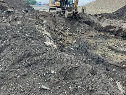 Excavator over the deep excavation. Site work, August 2026
